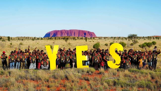 Elected representatives of remote communities in Central Australia pose in front of Uluru after their council meeting to vote 'Yes' to a voice to parliament. Picture: Tina Tilhard/Central Land Council/AFP