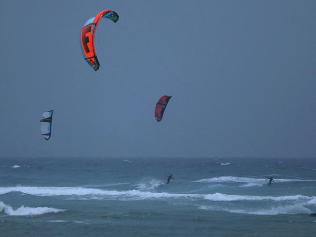 Kite surfers enjoy during the gutsy wind and rain near Currumbin beach, Coolangatta, Gold Coast. Photo: Regi Varghese