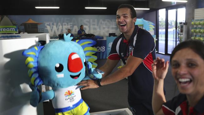 Athletes from the Falkland Islands play with popular Commonwealth Games mascot Borobi at the Games village. (AP Photo/Manish Swarup)