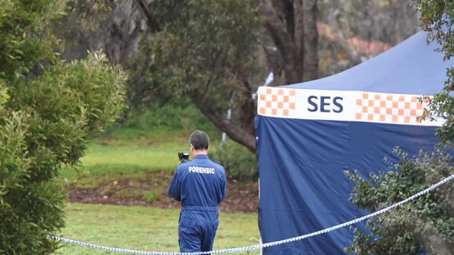 Forensic police carry out an investigation where the woman’s body was discovered. Picture: Jake Nowakowski