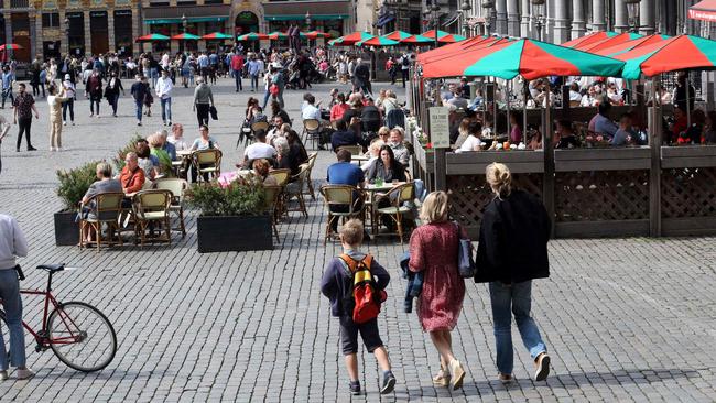 People sit at cafe terraces in Brussels on Sunday. Picture: AFP