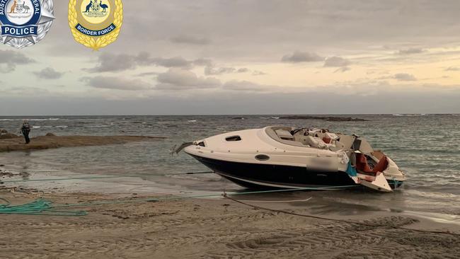 The boat was dragged ashore where it was searched with cocaine discovered aboard. Picture: AFP