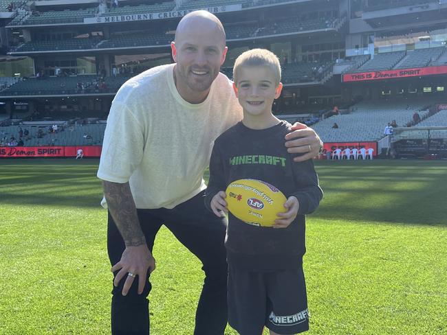 Nathan Jones with his son Remy kicking the footy on the G. Picture: Supplied