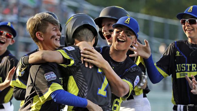 Australia's Stephen Courtney (7) celebrates with teammates after hitting a solo home run off Curacao. Picture: AP