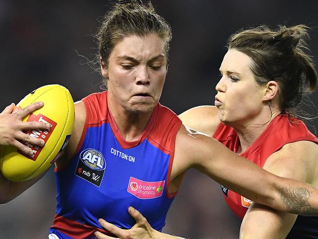 MELBOURNE, AUSTRALIA - MARCH 09: Ellie Blackburn of the Bulldogs is tackled by Elise O'Dea of the Demons during the round six AFLW match between the Western Bulldogs and the Melbourne Demons at Marvel Stadium on March 09, 2019 in Melbourne, Australia. (Photo by Quinn Rooney/Getty Images)