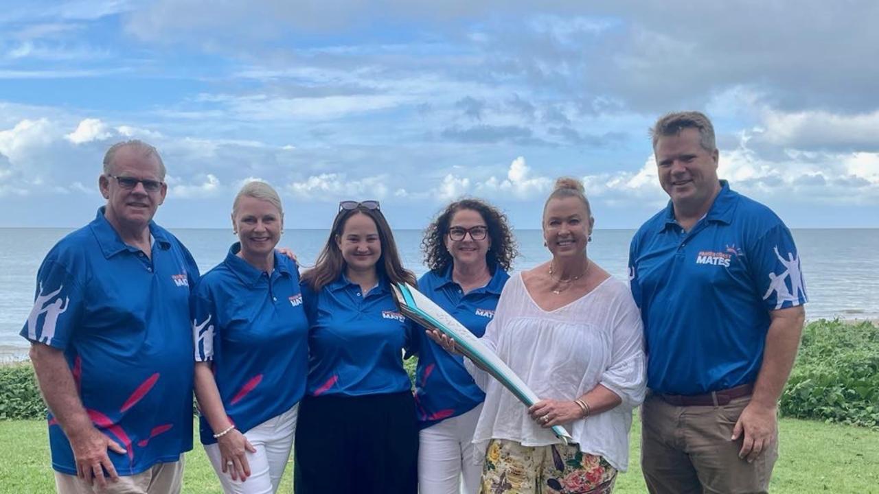 Olympian Lisa Curry with the Sydney Olympic torch and members of Fraser Coast Mates.