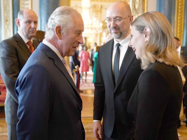 Britain's King Charles III speaks with Ukraine's First Lady Olena Zelenska and Ukraine's Prime Minister Denys Shmyhal as guests arrive for the palace reception. Picture: Jacob King/AFP