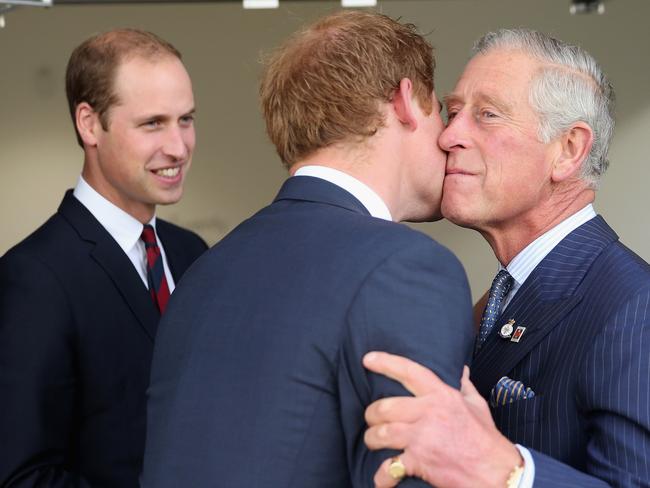 LONDON, ENGLAND - SEPTEMBER 10:  Prince Charles, Prince of Wales kisses his son Prince Harry as Prince William, Duke of Cambridge looks on ahead of the Invictus Games Opening Ceremony at Queen Elizabeth II Park on September 10, 2014 in London, England. The International sports event for 'wounded warriors', presented by Jaguar Land Rover, is just days away with limited last-minute tickets available at www.invictusgames.org  (Photo by Chris Jackson/Getty Images)