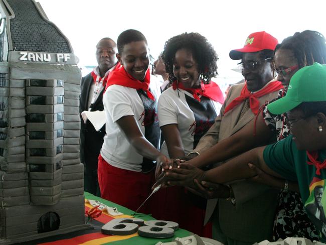 Lavish bash ... Zimbabwe's President Robert Mugabe celebrates his 89th birthday with his children Chatunga Mugabe (second left) and Bona Mugabe (centre) and his wife Grace Mugabe (second right) at Chipadze stadium in Bindura in 2013. Picture: AFP/Jekesai Njikizana