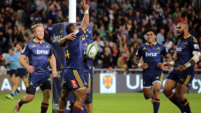 Waisake Naholo of the Highlanders celebrates his try with teammates.