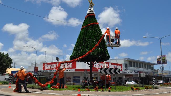 Burdekin Shire Council workers decorating the town's Christmas tree at the Queens and Edward St roundabout in 2013.