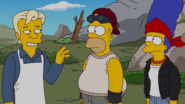 Homer and Marge meet their new neighbour Julian Assange on the show’s 500th episode. Picture: Fox