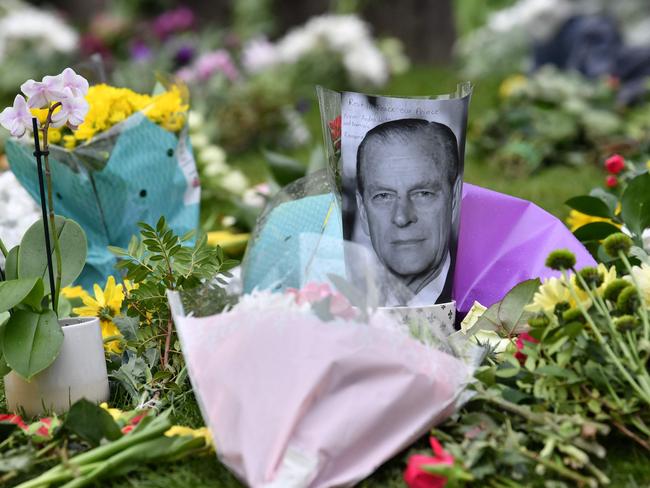 A photograph of Prince Philip among floral tributes outside Windsor Castle in Windsor, west of London. Picture: AFP