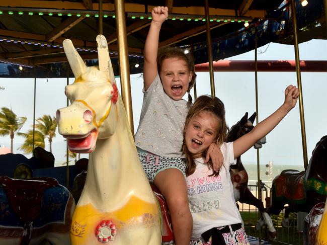 Laila, 5, and Skye Healing, 6, from Idalia go for a ride on the carousel at the Stable on the Strand. Picture: Evan Morgan