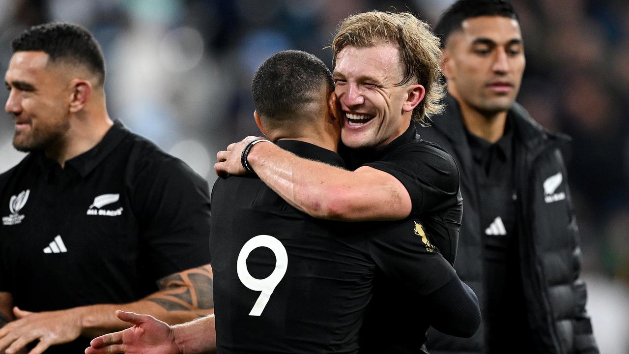 Damian McKenzie of New Zealand embraces teammate Aaron Smith. Photo by Hannah Peters/Getty Images.