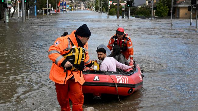 Emergency workers evacuate residents from flooded properties in Maribyrnong. Picture: AFP