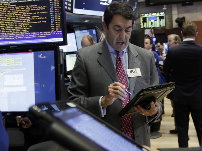 Trader Mark Muller works on the floor of the New York Stock Exchange, Monday, April 11, 2016. U.S. stocks opened higher on Wall Street following gains overseas as investors held out hope for more economic stimulus from China. (AP Photo/Richard Drew)