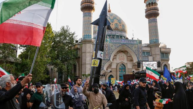 Iranians celebrate following Tehran’s missile and drone attack on Israel. Picture: AFP