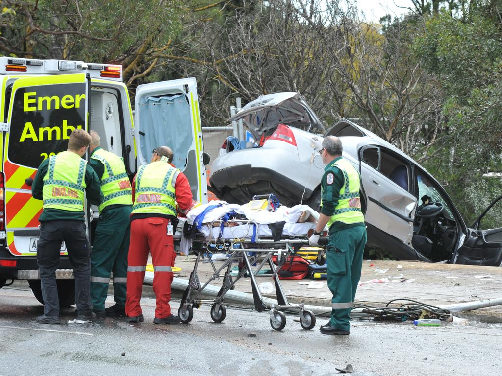 Emergency service workers at the crash on the corner of Glen Osmond and Cross roads. Picture: Roger Wyman