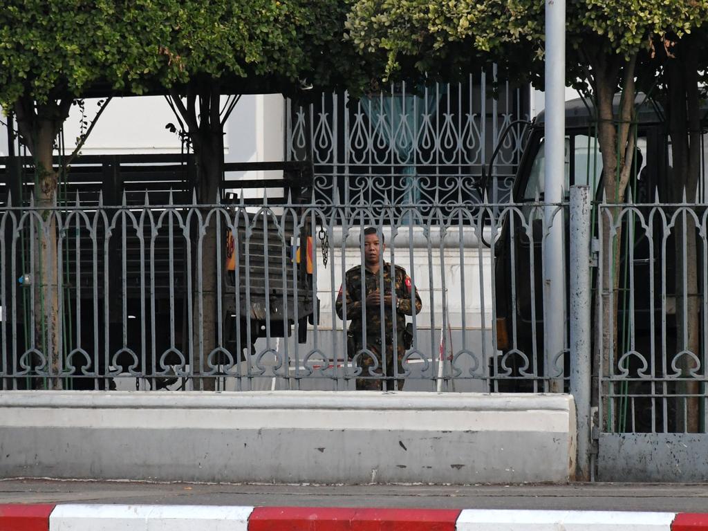 A soldier looks out from the City Hall compound in Yangon as Myanmar's military detained the country's de facto leader Aung San Suu Kyi and the country's president in a coup. Picture: STR