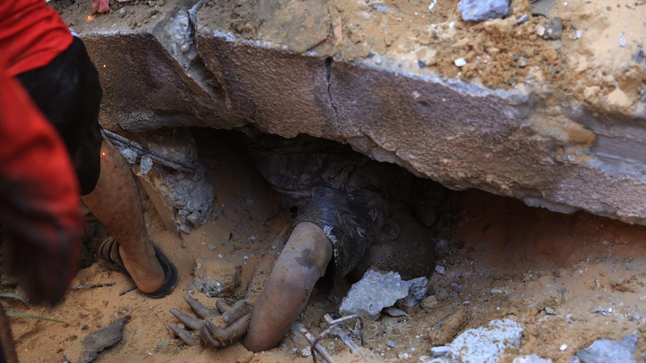 A Palestinian youth is pulled out from under the rubble of a building following an Israeli airstrike in Rafah, in the southern of Gaza Strip. Picture: AFP