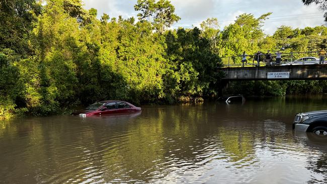 Cars submerged by floodwaters near Nambour Plaza on the Sunshine Coast. Photo: Mark Furler