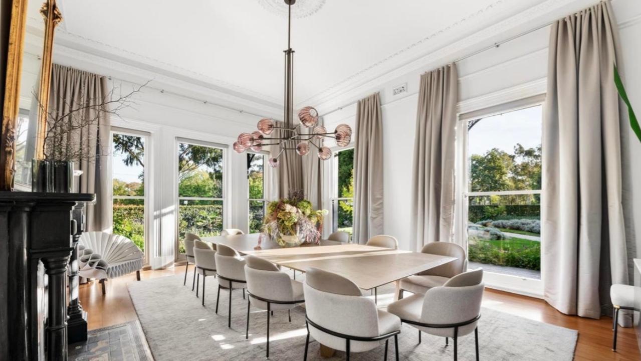The formal dining room at Cumnock offers garden views, period detailing and refined proportions, ideal for entertaining beneath soaring ceilings and amid heritage finishes.
