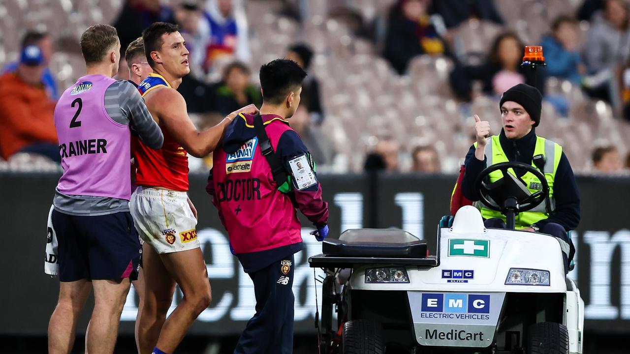 Hugh McCluggage is helped from the MCG. Picture: Dylan Burns/AFL Photos via Getty Images)