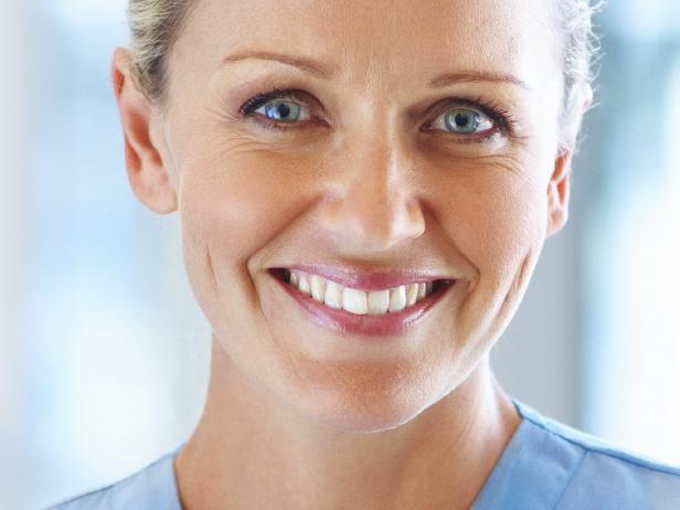 istock. Portrait of pretty female assistant with clipboard in hand