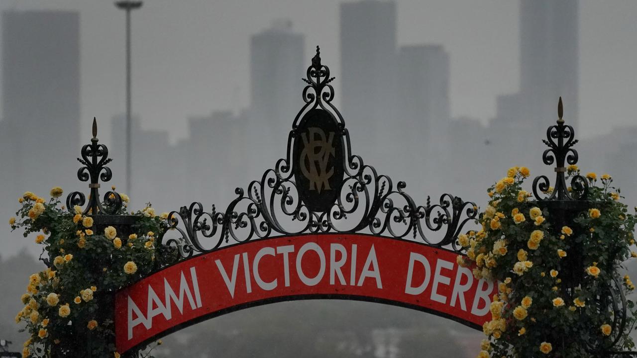 The heavens open above Flemington on Derby Day morning. Picture: AAP