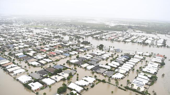 The continued inundation forced authorities to open the floodgates on the swollen Ross River dam on Sunday night. (Photo by Ian Hitchcock/Getty Images)