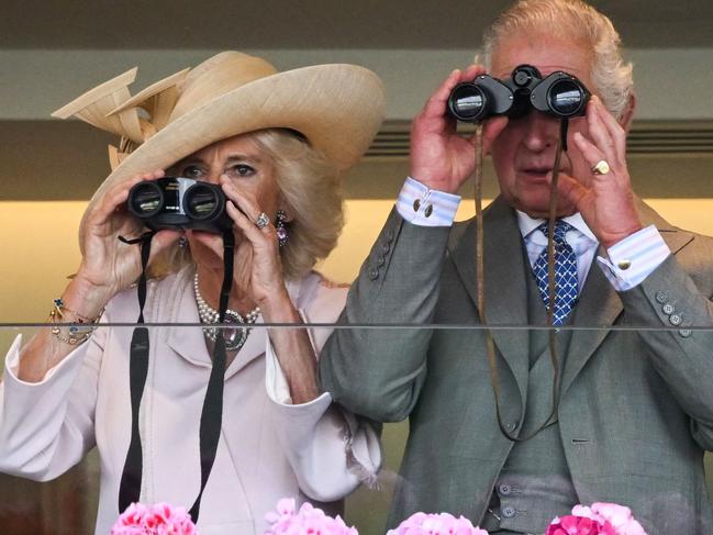 Britain's Queen Camilla (L) and Britain's King Charles III (R) watch the races with their binoculars on the second day of the Royal Ascot horse racing meeting, in Ascot, west of London, on June 21, 2023. (Photo by JUSTIN TALLIS / AFP)