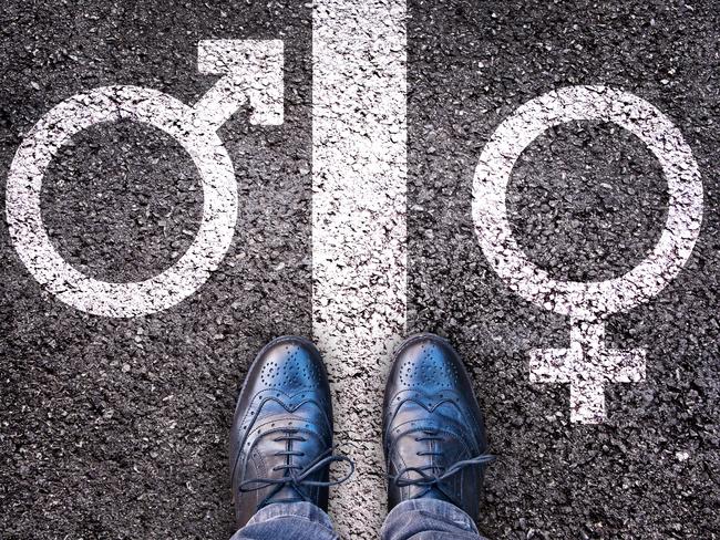 Legs with gender symbol on asphalt, gender concept. Istock