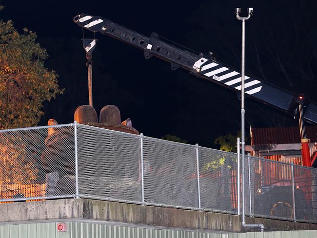 Heavy machinery lifts a carriage of the ride at the centre of the incident at Dreamworld. Picture: Marc Robertson