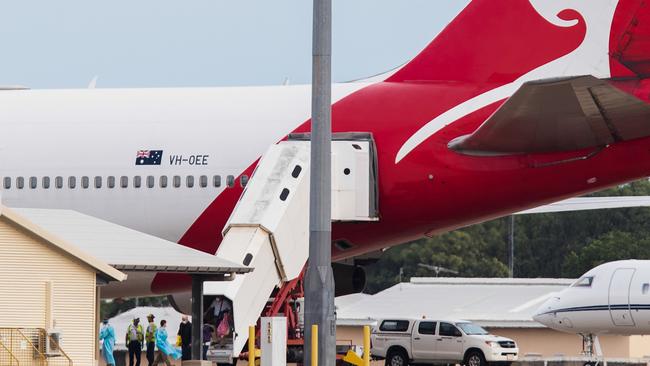 Australian evacuees from the coronavirus-struck cruise ship Diamond Princess deplane a Qantas flight from Japan at Darwin International Airport in Darwin, Thursday, February 20, 2020. Hundreds of Australians evacuated from the Diamond Princess will be quarantined at a workers camp in Howard Springs. Picture: AAP Image/Helen Orr