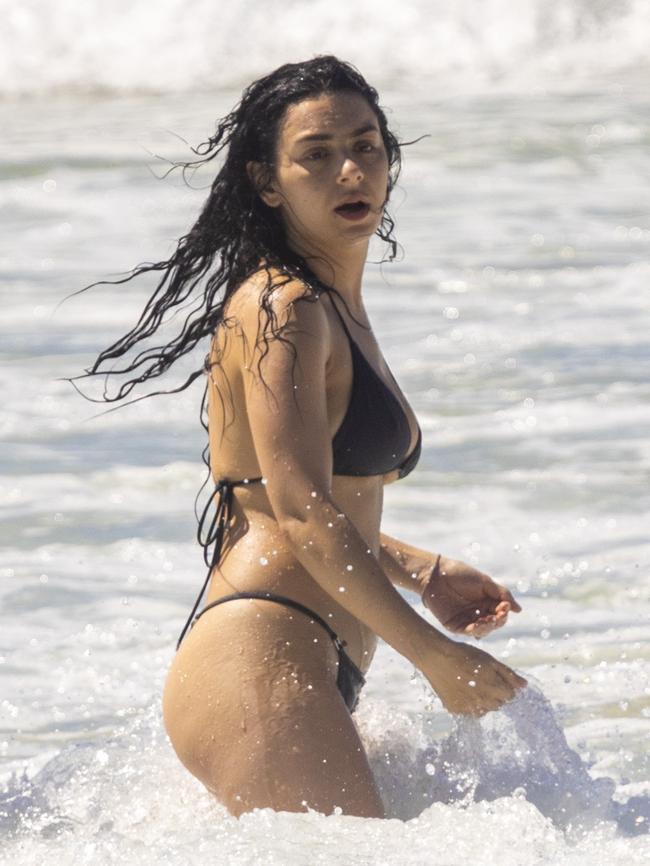 The star showed off her physique as she enjoyed the surf. Picture: Media Mode.