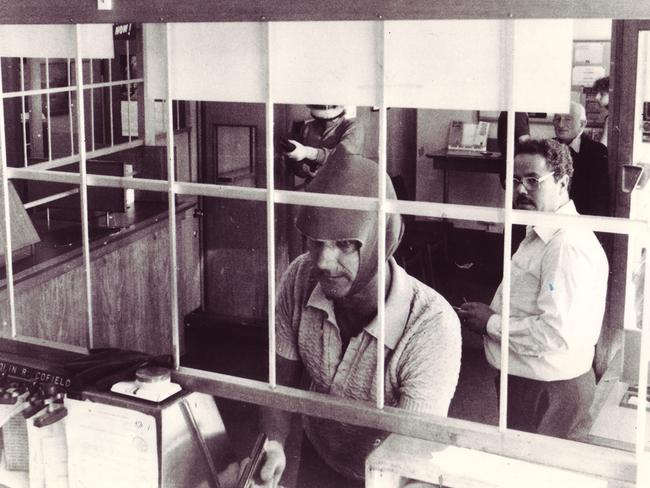 A bandit in a barely effective mask holds up a bank in Hawthorn in 1981.