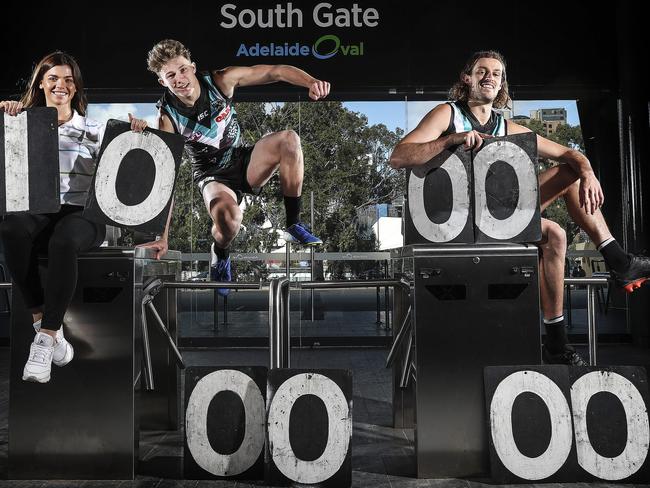 The Adelaide Oval will celebrate another milestone on Saturday night when its 10 millionth fan comes through the gates during the Port Adelaide v Geelong match. Port fan Candice Belperio is pictured with Port players Xavier Duursma and Jarrod Lienert. Picture SARAH REED