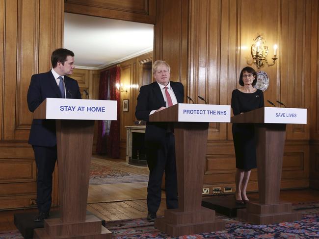 Britain's Prime Minister Boris Johnson, is joined by Housing, Communities and Local Government Secretary Robert Jenrick, left, and Deputy Chief Medical Officer Jenny Harries, right, on Sunday. Picture: AP