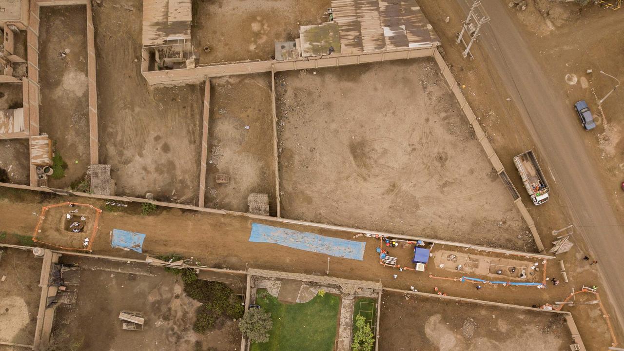In this aerial view archaeologists recover ancient human remains and artifacts discovered by workers excavating a street in a rural area in the northern district of Carabayllo in Lima, on September 22, 2023. Picture: Cris Bouroncle / AFP