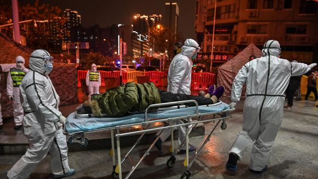 Medical staff arrive with a patient at the Wuhan Red Cross Hospital in Wuhan in January, 2020.