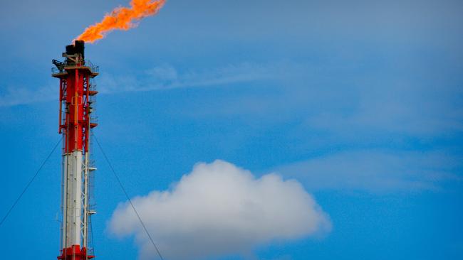 A flame blazes on top of a flare stack at the Queensland Curtis Liquefied Natural Gas (QCLNG) project site.