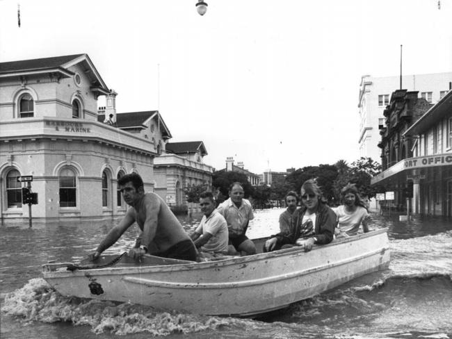 People in boat passing Port Office Hotel in Edward St City.