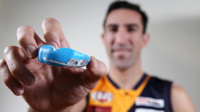 Ex-Roos AFL player Michael Firrito with the new Aussie-made microchipped mouthguard. Picture:” Michael Klein