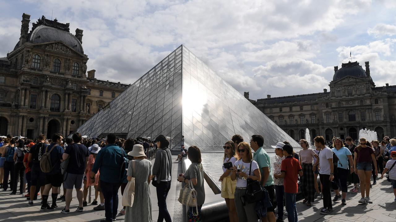 Tourists queue outside the Pyramid before entering the Louvre museum in Paris. Picture: Alain Jocard/AFP
