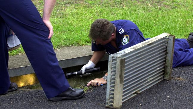 NSW Police search for evidence in drain near the little girl’s house in January, 2001.