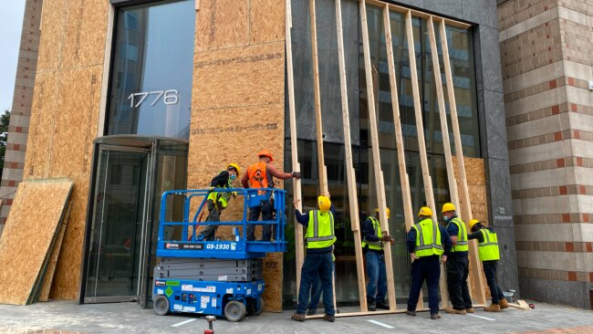 Workers put in place their Biden boards