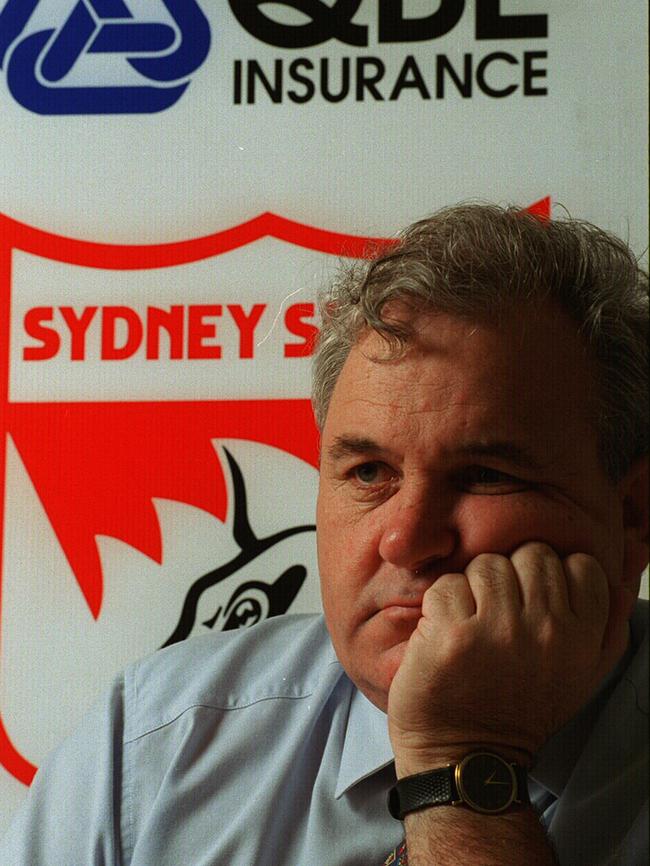 Football executive player manager Ron Joseph Apr 1998 in front of Sydney Swans logo. p/