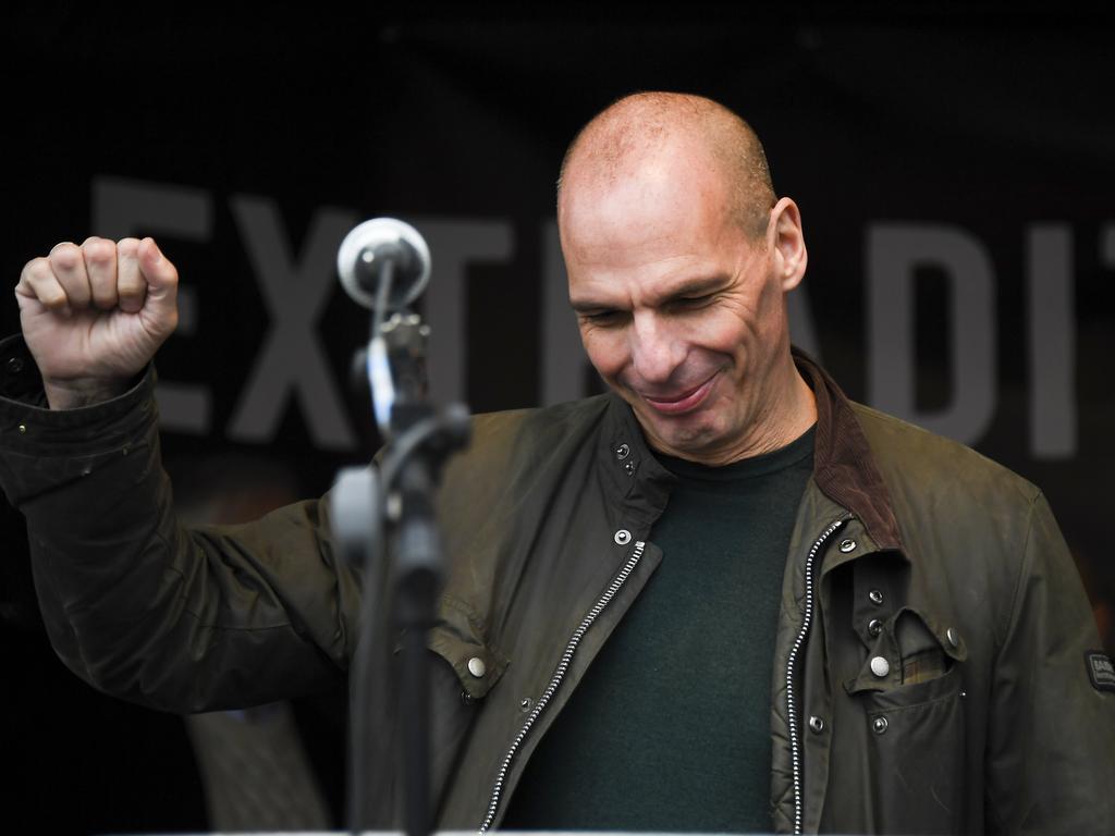 Greek economist Yannis Varoufakis seems a little reluctant to go the full fist pump at the Assange rally. Picture: AP