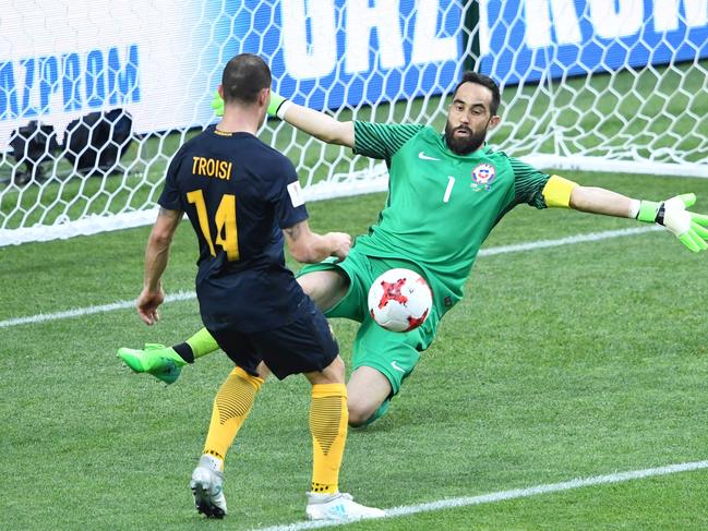 Australia's forward James Troisi scores in the nets of Chile's goalkeeper Claudio Bravo during the 2017 Confederations Cup group B football match between Chile and Australia at the Spartak Stadium in Moscow on June 25, 2017. / AFP PHOTO / Natalia KOLESNIKOVA